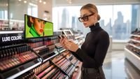 A blonde women shops for makeup with digital signage helping. 