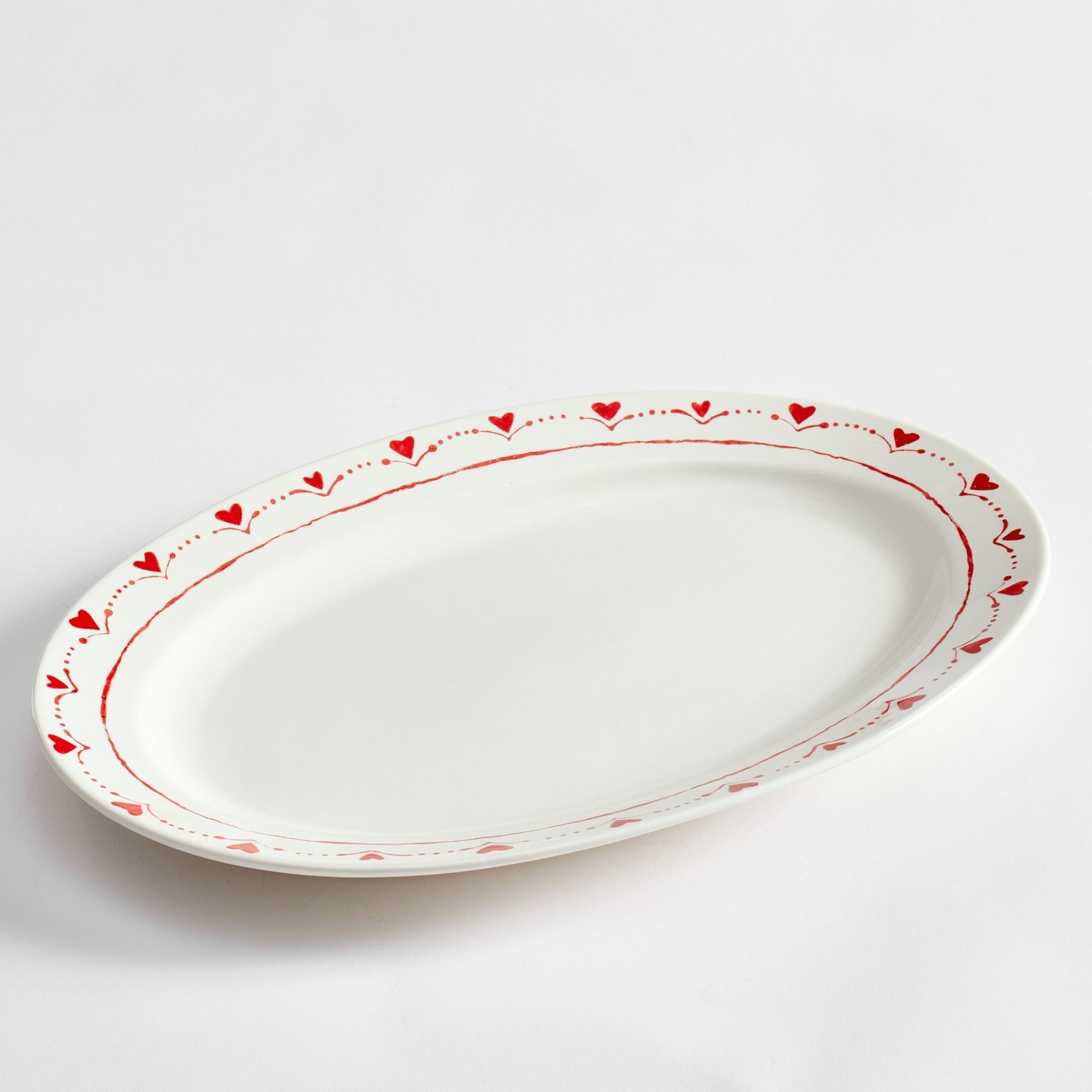 White oval platter with red heart trim
