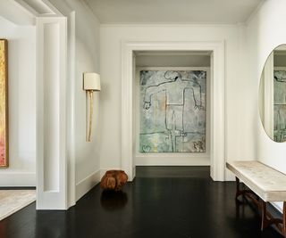 Hall with large artwork and white walls