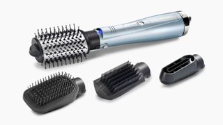 A press shot of the babyliss 4 in 1 hydro fusion hair dryer for fine hair with three attachments pictured, on a white background