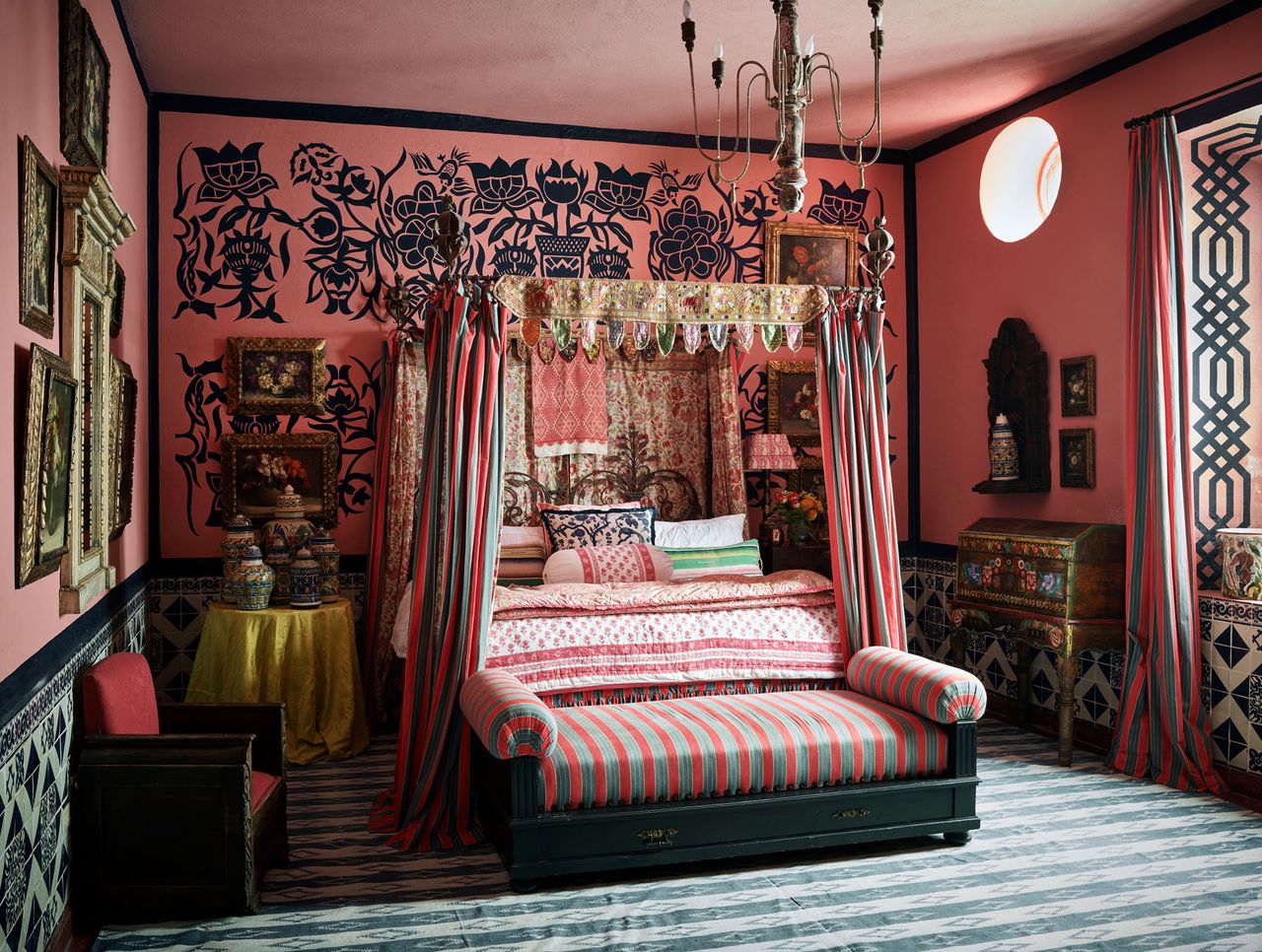 Pink bedroom with black flower paining's, fourposter bed with green and pink curtains