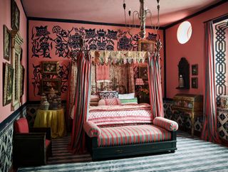 Pink bedroom with black flower paining's, fourposter bed with green and pink curtains