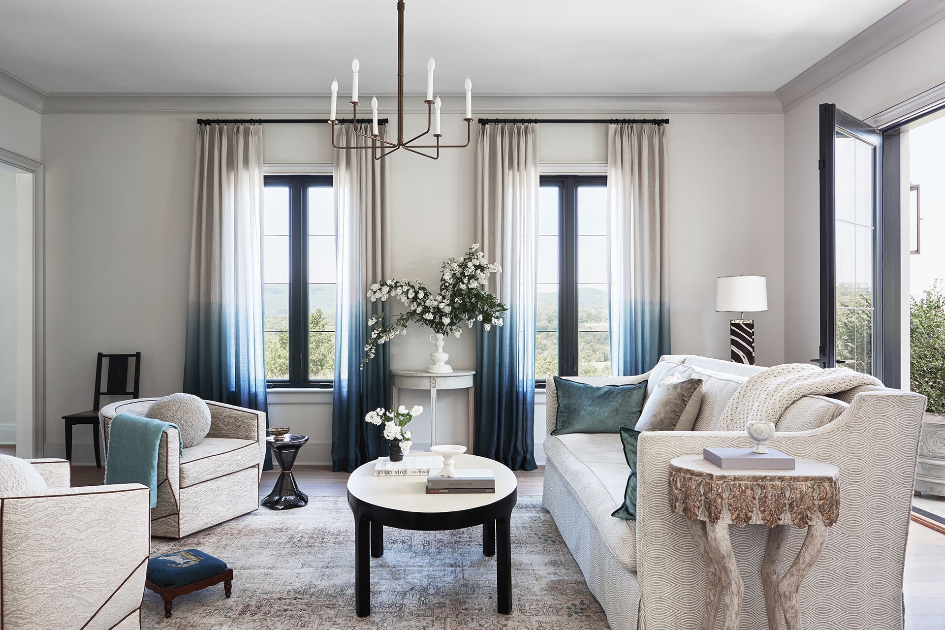 white living room with white walls and funriture and blue accents