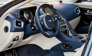 Interior of Aston Martin DB11 featuring cream and blue trim on dashboard and console