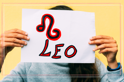 a person holding up a leo sign on a piece of paper with a pink border