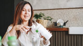 Woman making protein shake at home