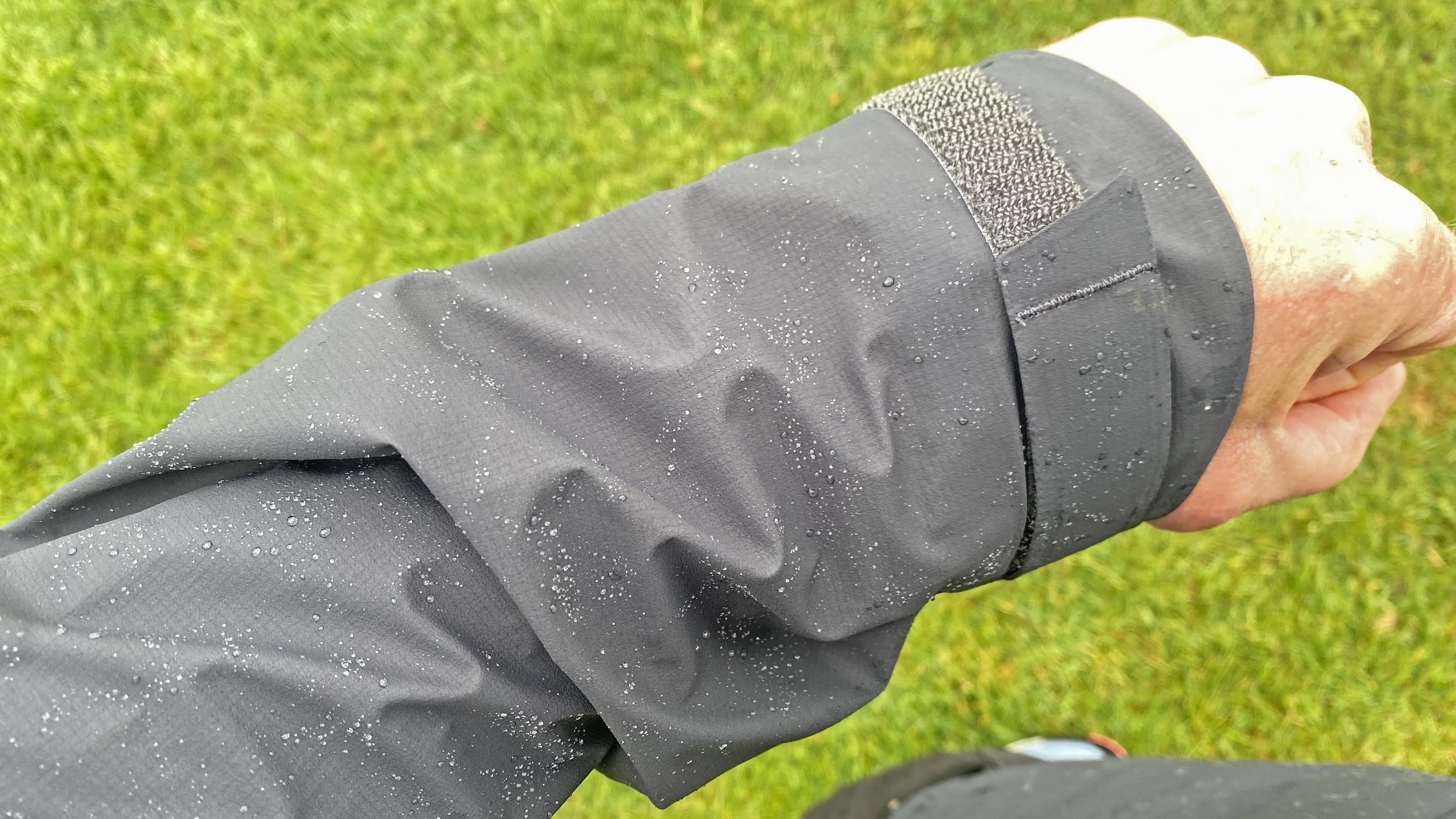 Close up of the Haglöfs L.I.M ZT II GTX jacket, showing the Velcro sleeves and water repellency