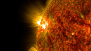 A solar flare captured by NASA's Solar Dynamics Observatory in extreme ultraviolet light. Here we see a fiery orange and black orb and at one point a white-hot explosion taking place.