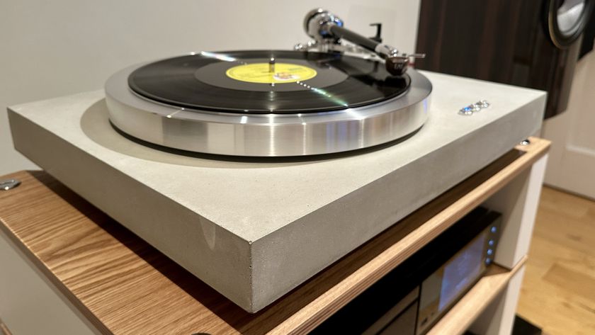 The EAT C-Dur Concrete turntable on a wooden shelf