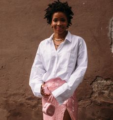 woman wearing white button-up shirt and pink skirt