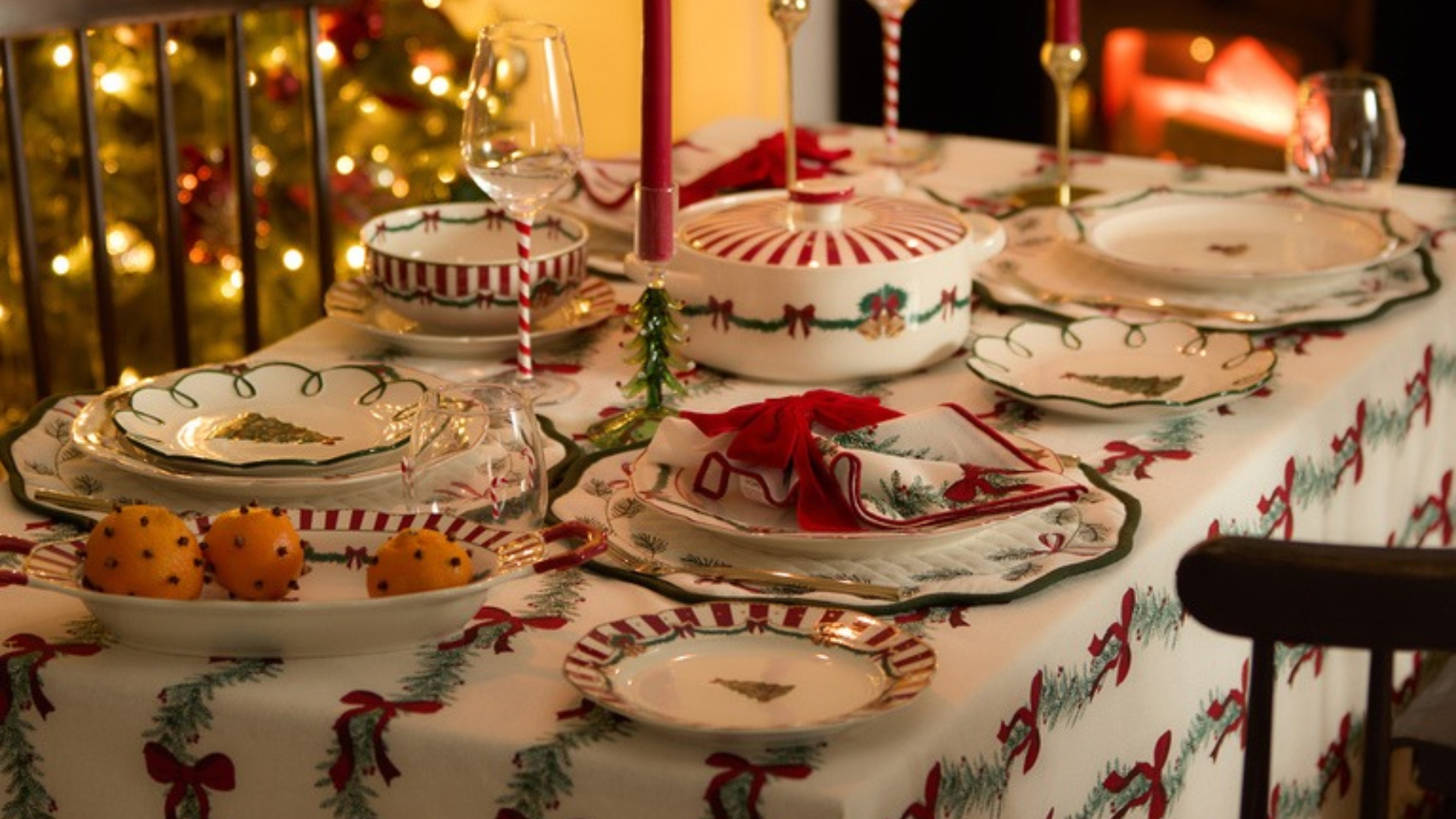 Primark Christmas cooware on a decorated table in front of a Christmas tree.