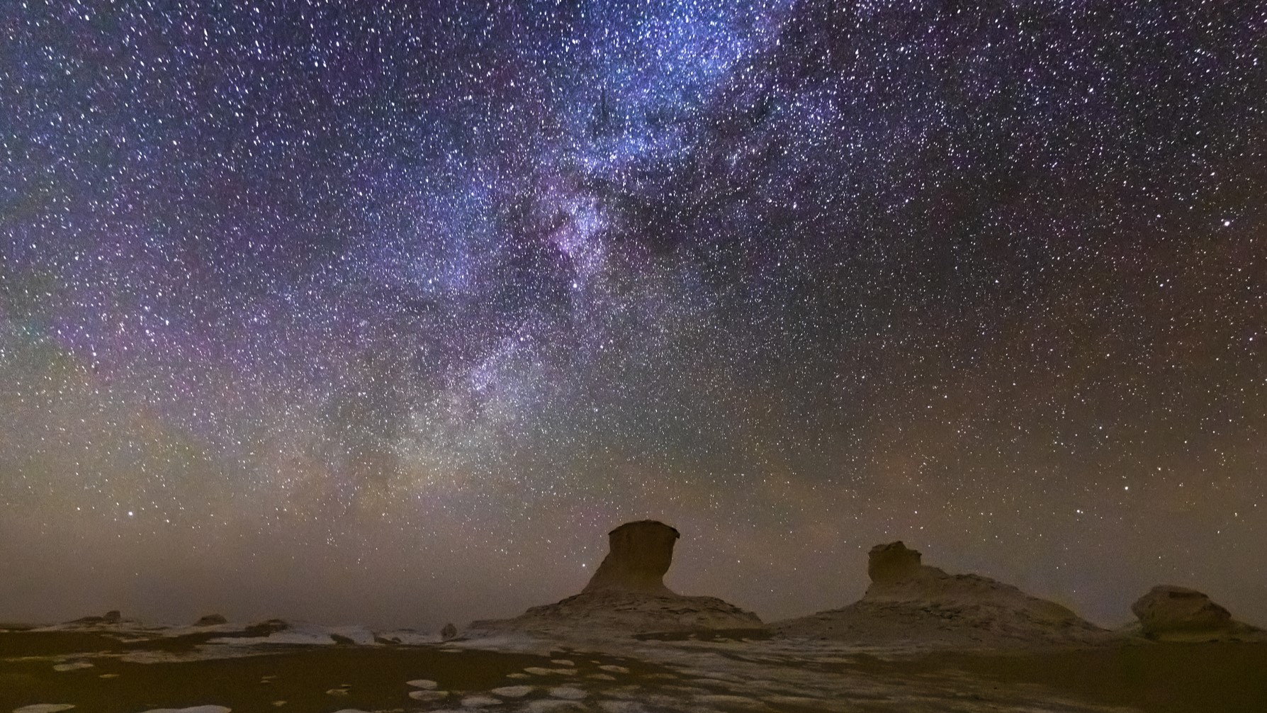 Beautiful starry night sky over a desert landscape in the White Desert. Egypt