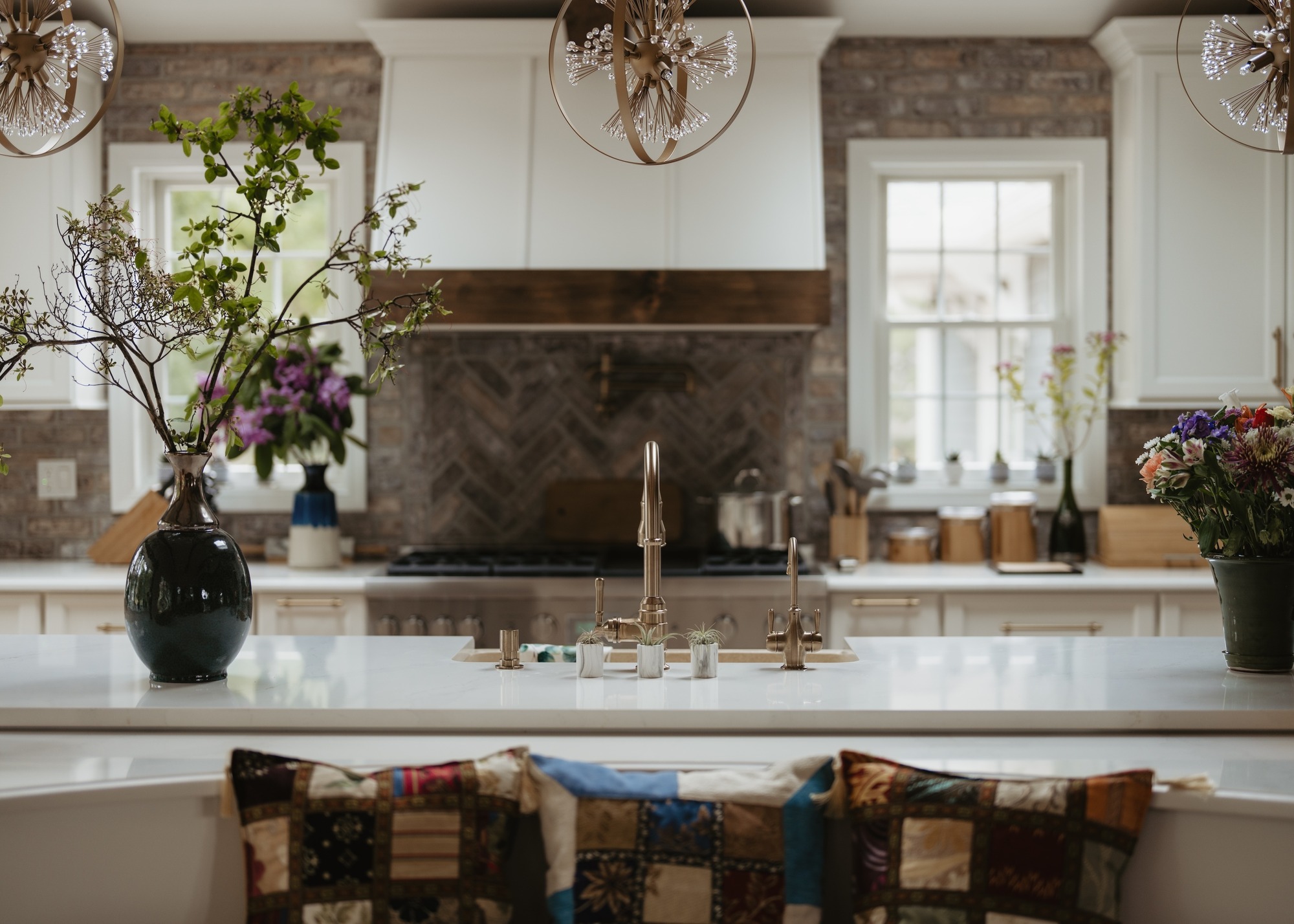 white kitchen countertop with brass tap