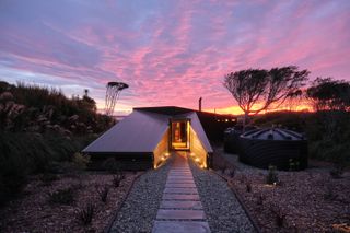 Exterior of minimalist New Zealand house at sunset
