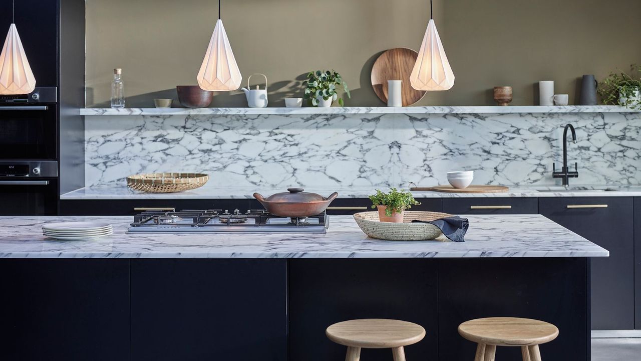 Green walls, hanging lights, kitchen island, pot