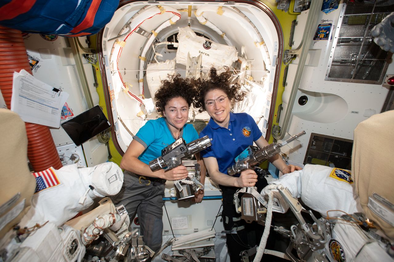 NASA astronauts Jessica Meir (left) and Christina Koch are inside the Quest airlock preparing the U.S. spacesuits and tools they will use on their first spacewalk together.