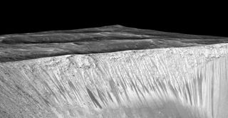 The dark streaks on some Martian slopes known as recurring slope lineae — imaged here by NASA’s Mars Reconnaissance Orbiter — may be caused by salty liquid water, some scientists think. 