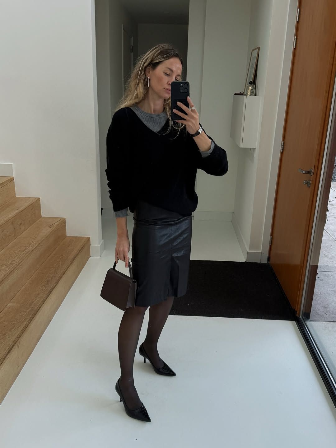 @anoukyve wearing jumper and leather skirt