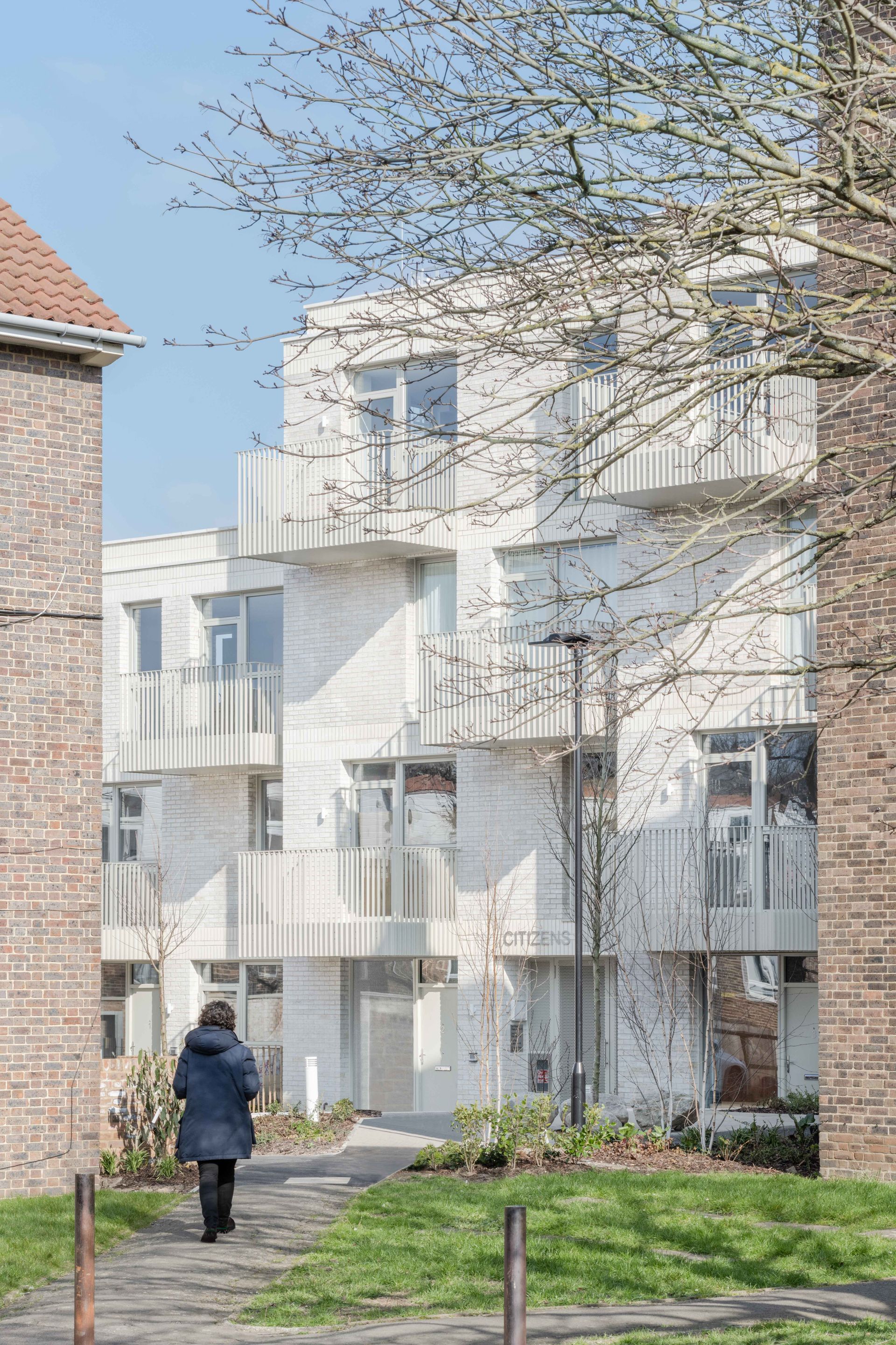approaching the white brick volume of citizens house by archio in south london