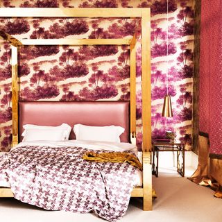 bedroom with wall paper and pink with wooden bed