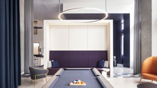 Bold colour fabrics liven this minimalist concrete apartment interior