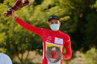 QURAYYAT OMAN FEBRUARY 12 Anthon Charmig of Denmark and UNO X Pro Cycling Team celebrates winning the Red Leader Jersey on the podium ceremony after the 11th Tour Of Oman 2022 Stage 3 a 180km stage from Sultan Qaboos University to Qurayyat 240m TourofOman on February 12 2022 in Qurayyat Oman Photo by Dario BelingheriGetty Images