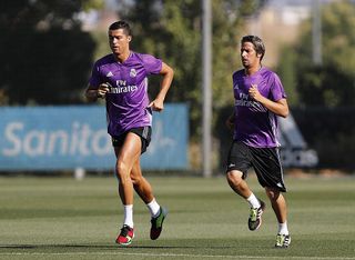 Cristiano Ronaldo (L) and Fabio Coentrao of Real Madrid warm up during a training session at Valdebebas training ground on August 20, 2016 in Madrid, Spain