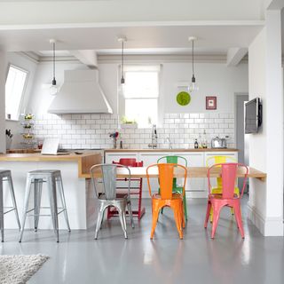 kitchen with orange chair and white floor