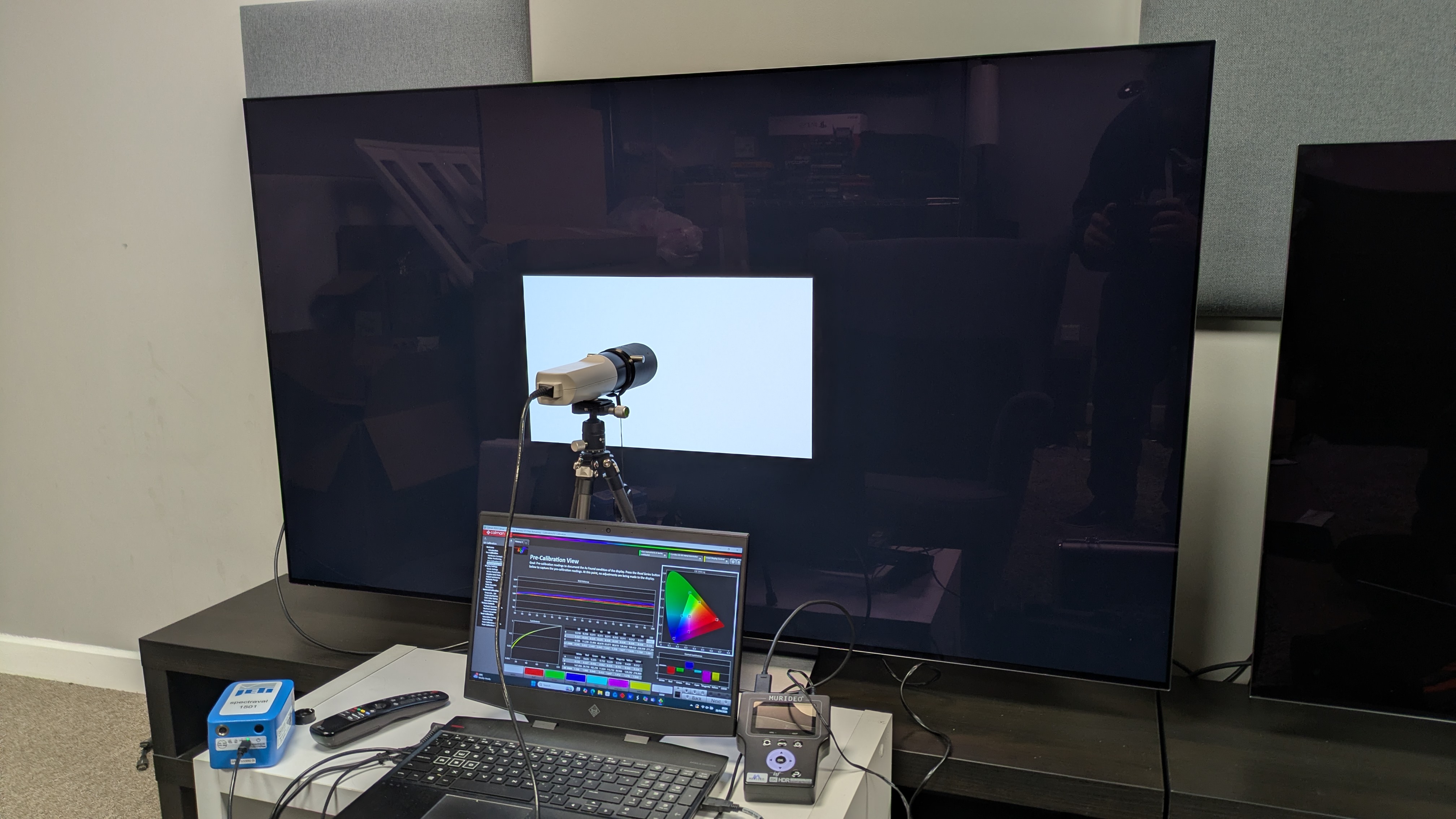 LG C6 OLED TV with Klein K-10A colorimeter in front of white window pattern. Portrait Displays Calman software on laptop and Murideo Six G 8K metal test pattern generator also attached