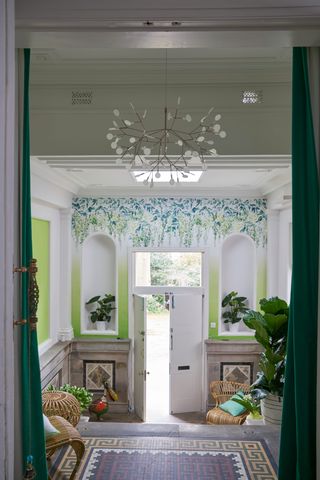 Green hallway with floral mural painted from ceiling