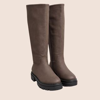 Flat lay image of flat brown knee high boots