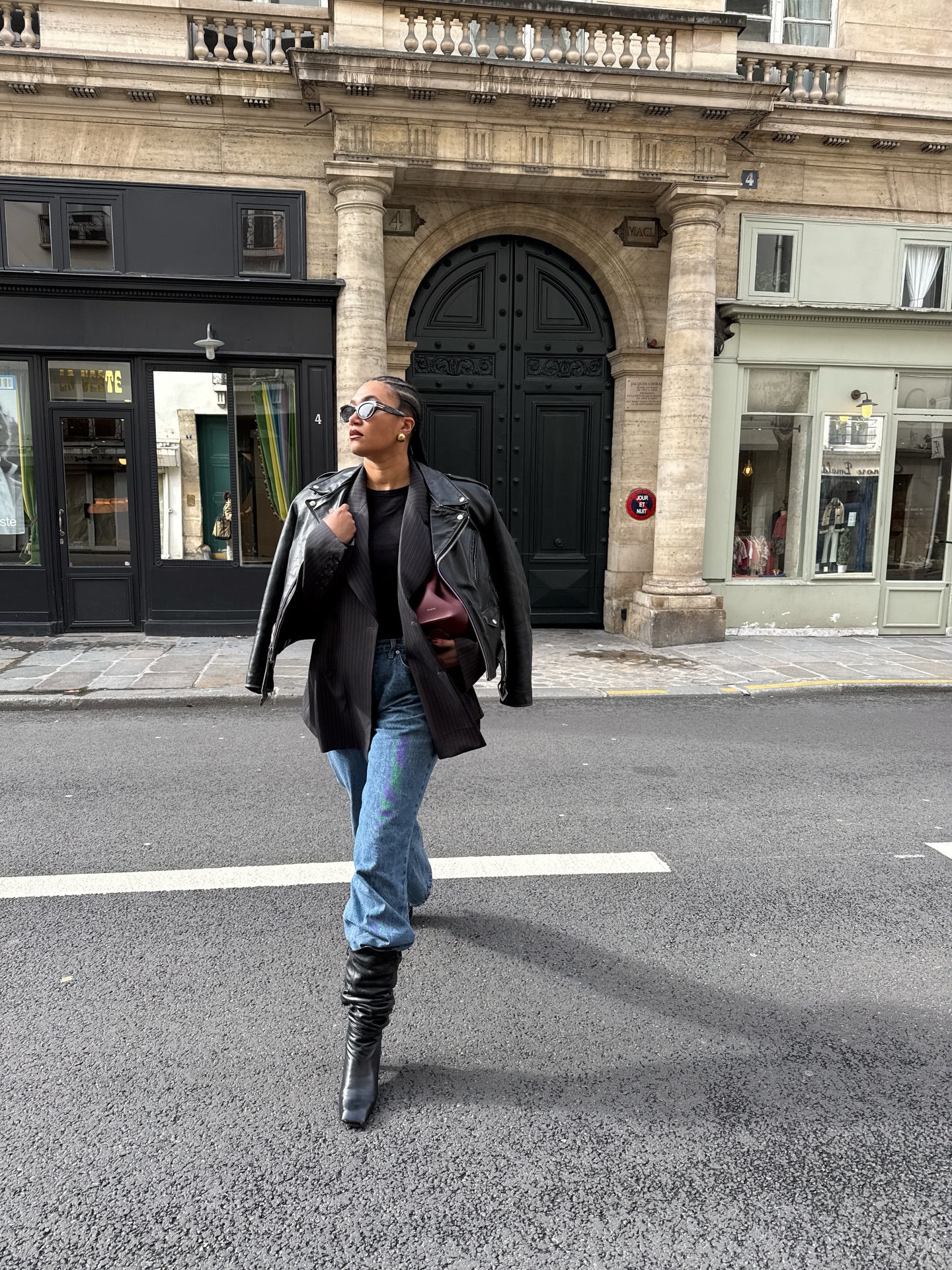 An image of @lenafarl wearing jeans tucked into kitten-heel boots.