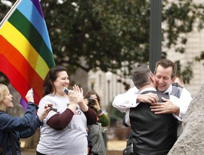 A couple embraces after getting married outside the Jefferson County Courthouse in Birmingham, Alabama, February 9.