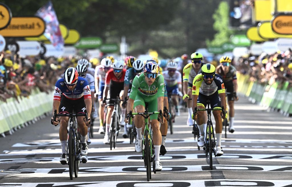 JumboVisma teams Belgian rider Wout Van Aert wearing the sprinters green jersey C cycles to the finish line with the pack of riders during the 13th stage of the 109th edition of the Tour de France cycling race 1926 km between Le Bourg dOisans in the French Alps and SaintEtienne in central France on July 15 2022 Photo by AnneChristine POUJOULAT AFP Photo by ANNECHRISTINE POUJOULATAFP via Getty Images