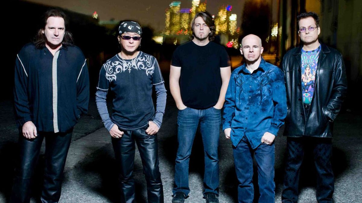 Spock&#039;s Beard stand in front of city lights with their hands in their pockets, circa 2013