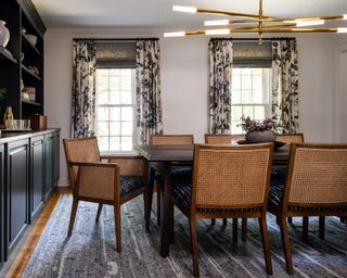 Dining room curtain ideas with patterned curtains over a grey linen blind