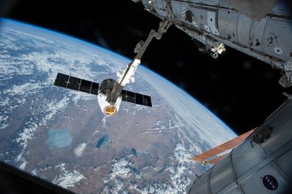 SpaceX Dragon cargo spacecraft attaches to the International Space Station.