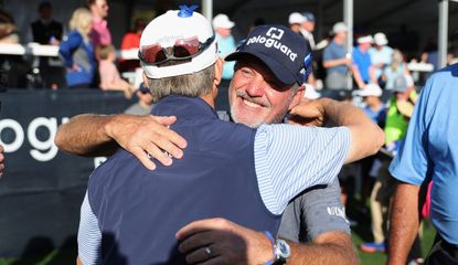 Kelly hugs a golfer after winning a trophy
