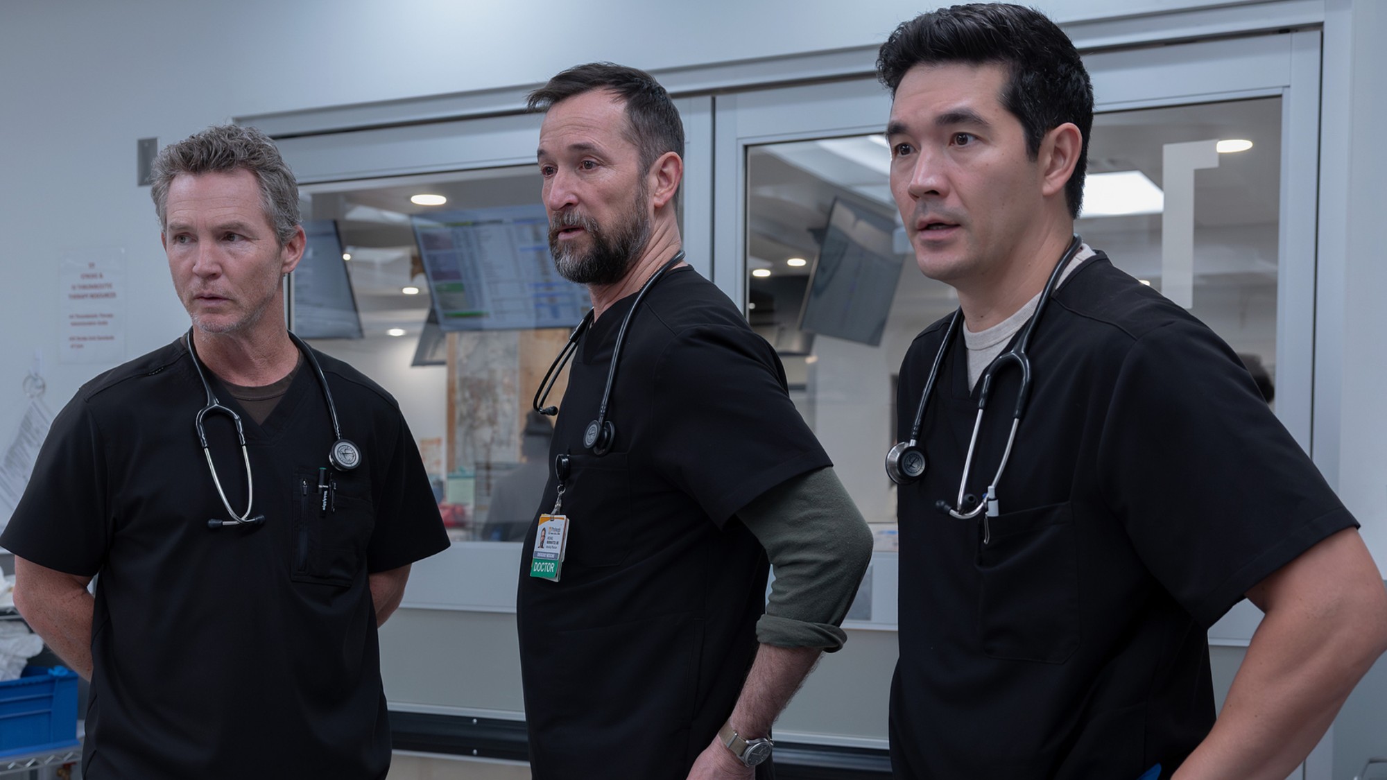 From left to right: Abbot, Robby and Shen all standing together in The Pitt. 