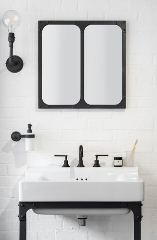 Black and white bathroom with larger mirrors