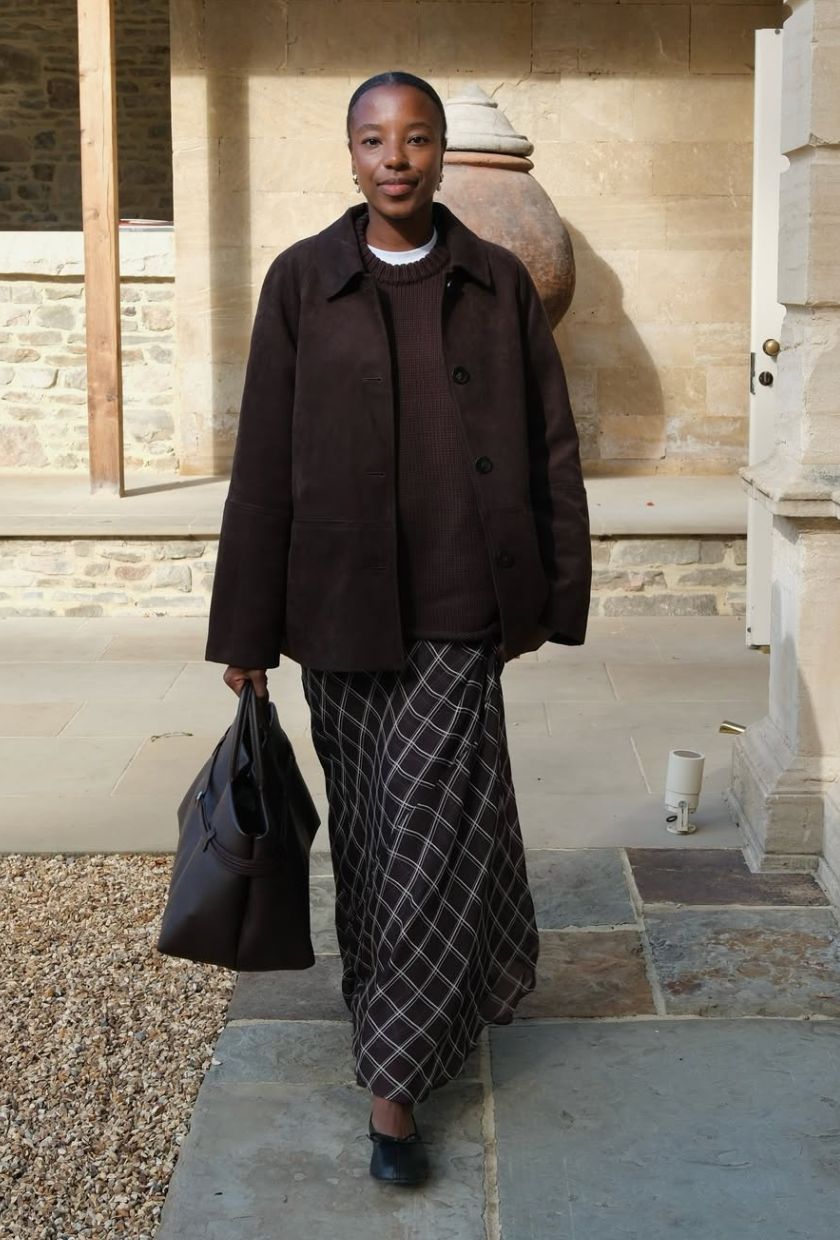 @taffymsipa wears a brown suede jacket, cashmere jumper, check skirt and black ballet flats