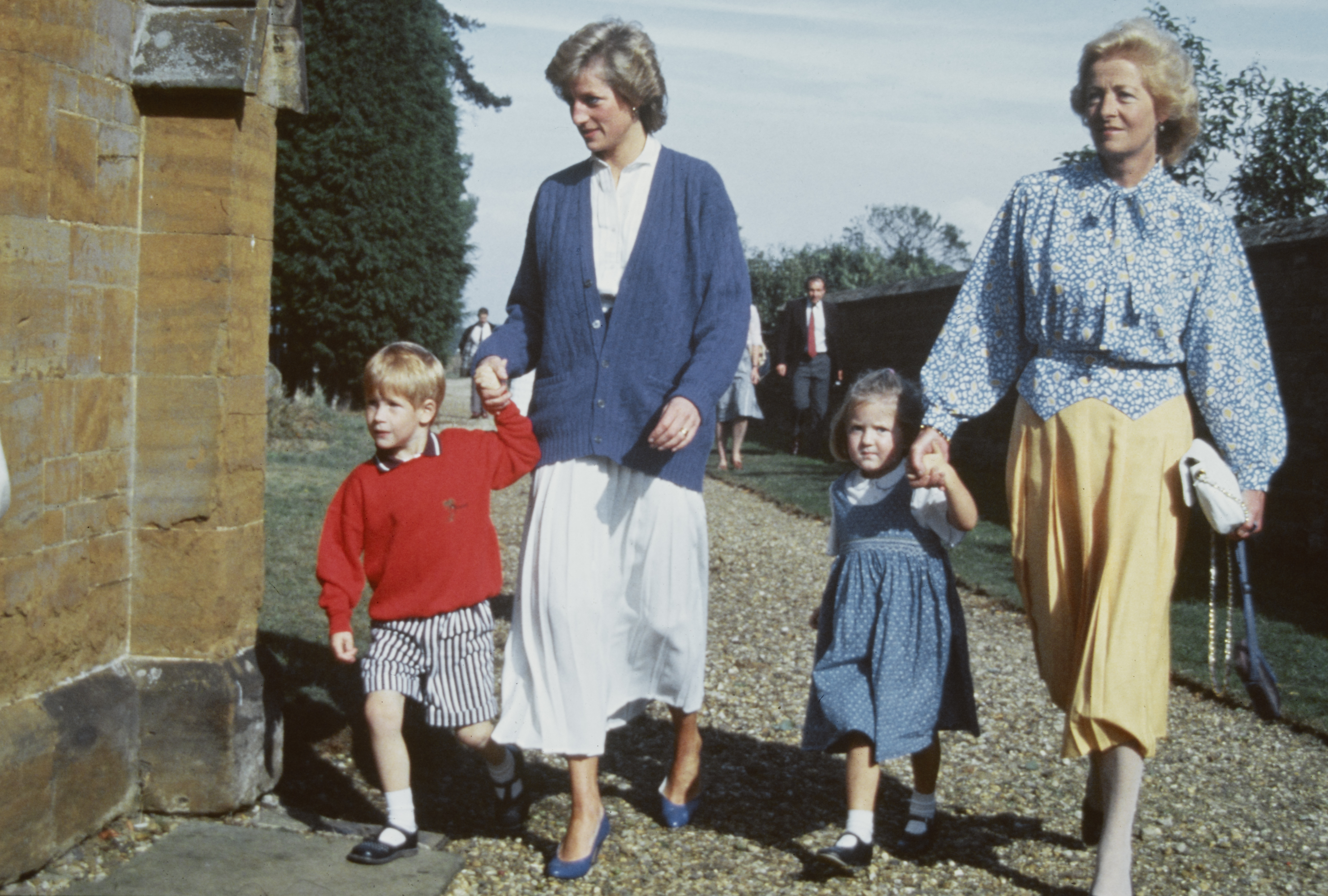 Princess Diana holding hands with Prince Harry walking next to her mother Frances Shand Kydd