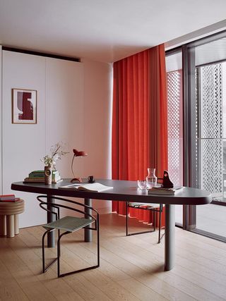 Study with red curtains in the Penthouse apartment interior by fashion designer Roksanda Ilincic at Gasholders