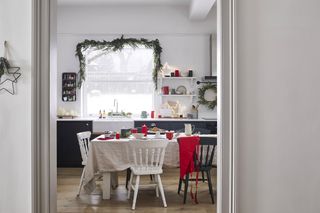 Christmas window decor with garland and wreath in kitchen by Lights4Fun