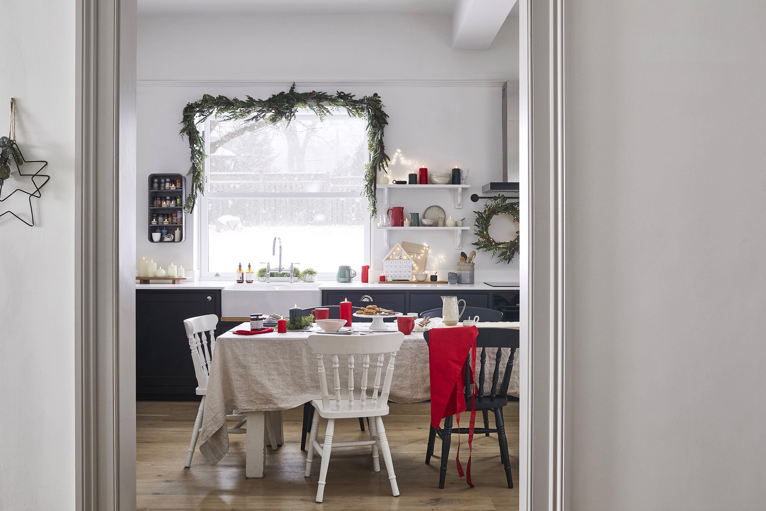 Christmas window decor with garland and wreath in kitchen by Lights4Fun