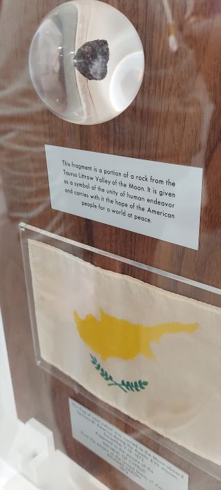 The Apollo 17 goodwill moon rock display for the people of Cyprus includes a Cypriot flag flown on the mission.