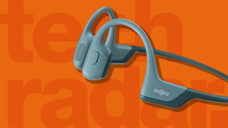 Best running headphones: Pictured here, the Shokz OpenRun Pro running headphones on orange background