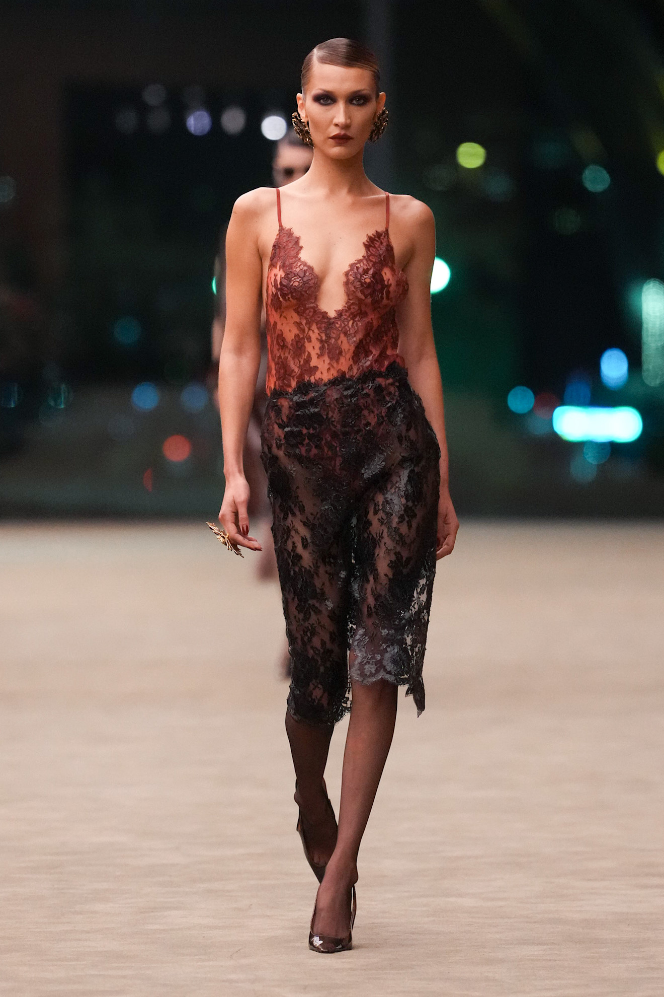 Bella Hadid returned to Saint Laurent's runway in a lingerie-inspired, Fall 2026 lace skirt set