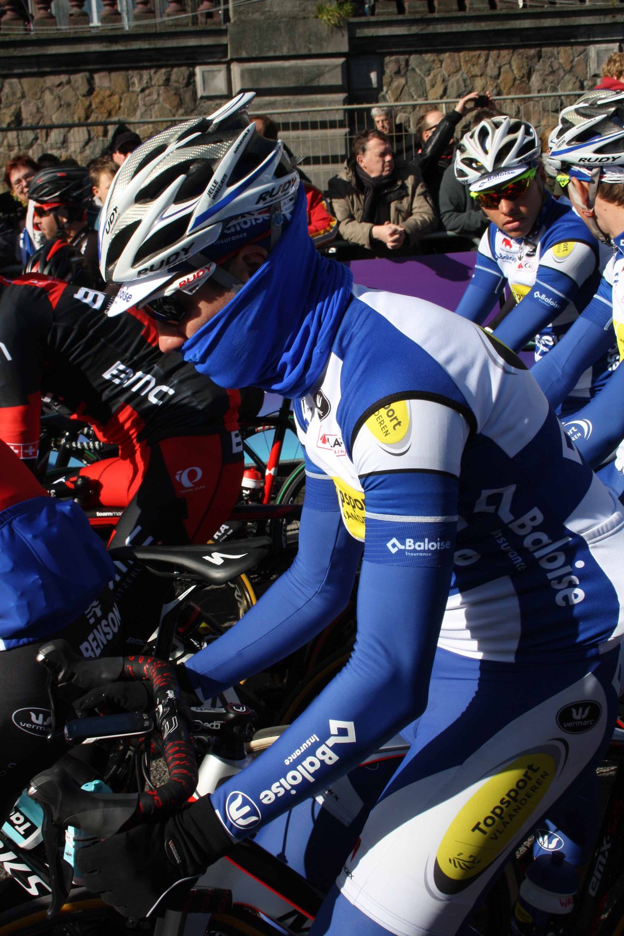 Despite the sunshine, many riders were wrapped against the chill ahead of Omloop Het Nieuwsblad.