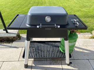 Everdure Force 2 BBQ in garden on patio with grass behind